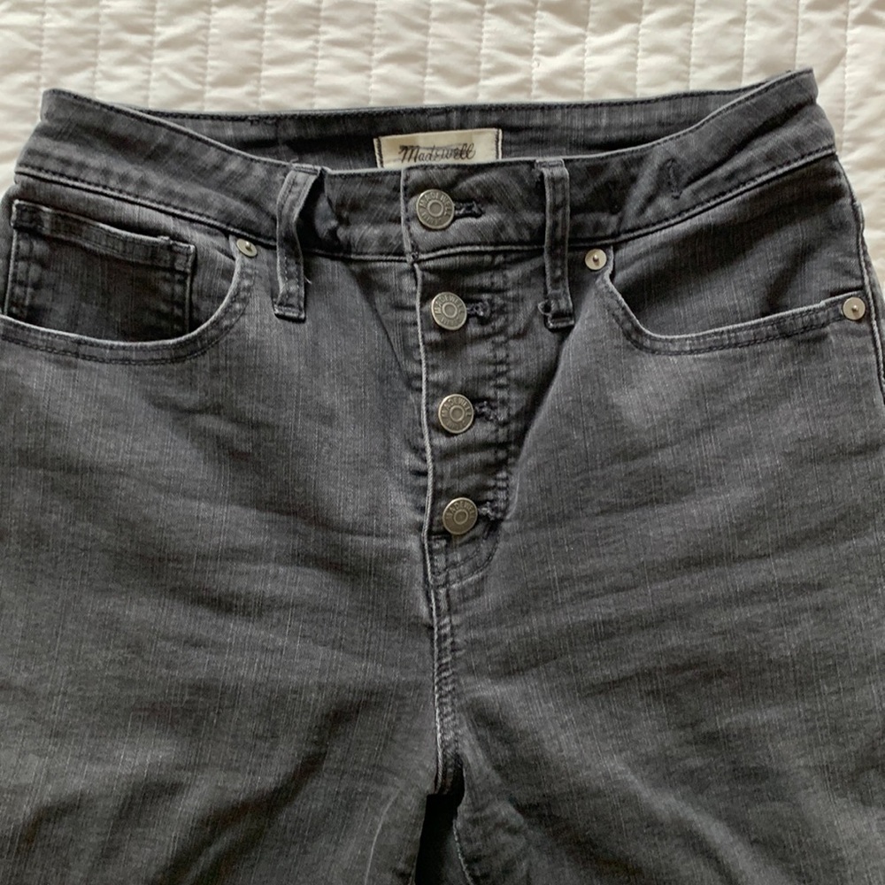 Black button fly skinnies with frayed hem